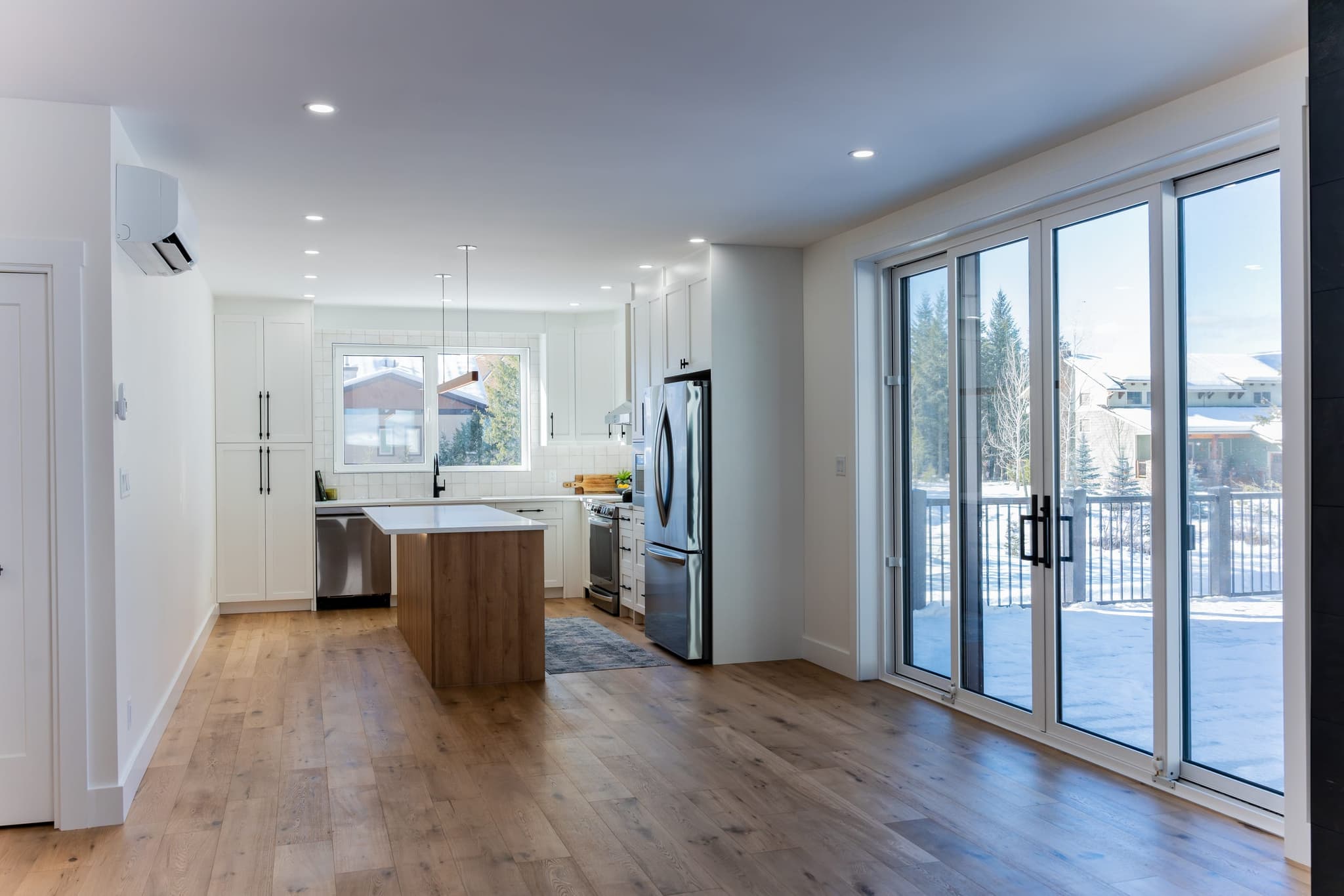 Bright open-concept kitchen by Alpine View Construction