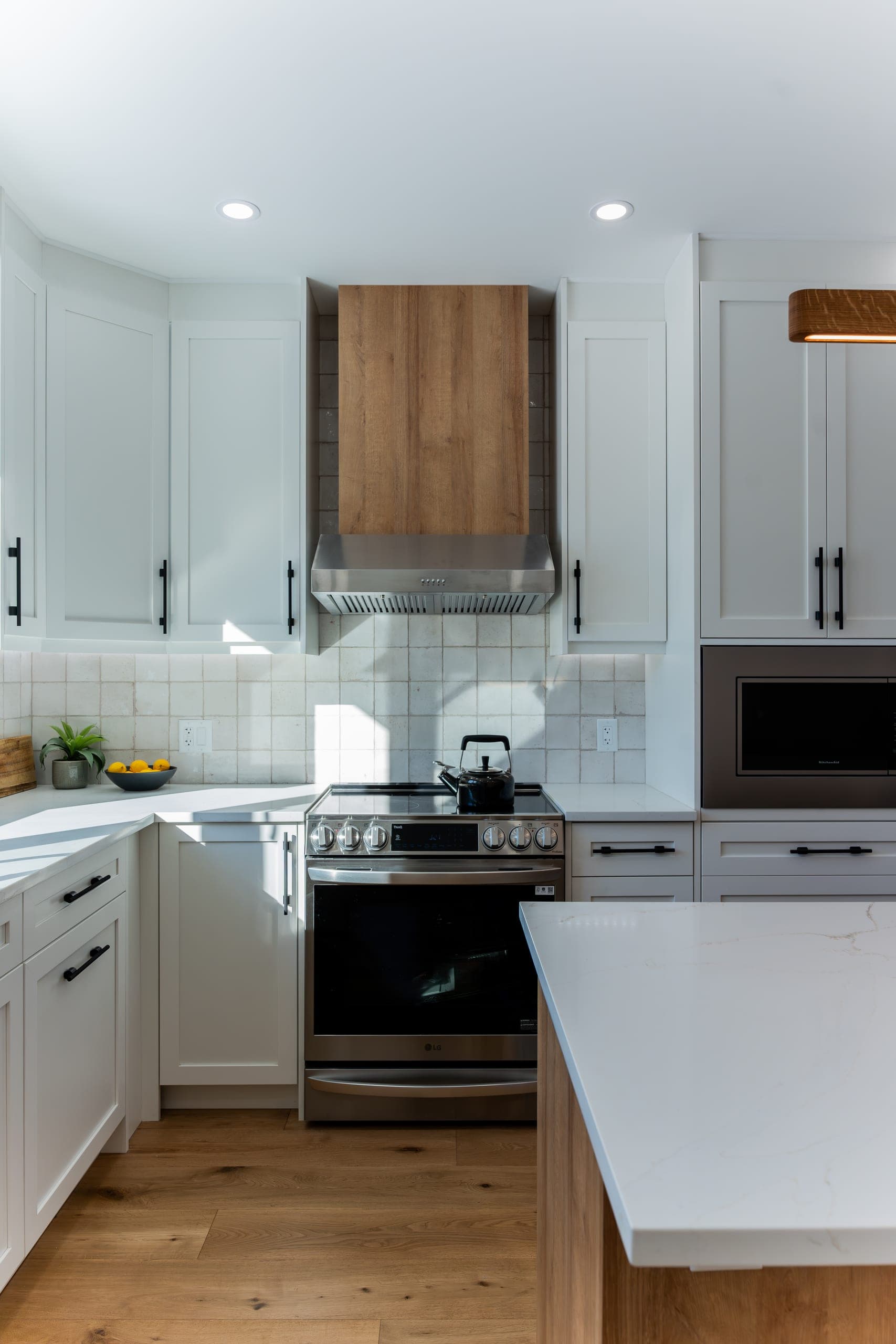 Custom wood range hood over slide-in range — kitchen remodel detail