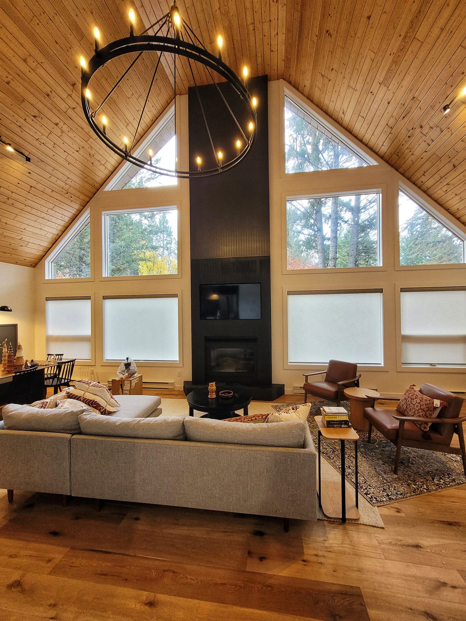 Cottage great room with vaulted timber ceiling and chandelier